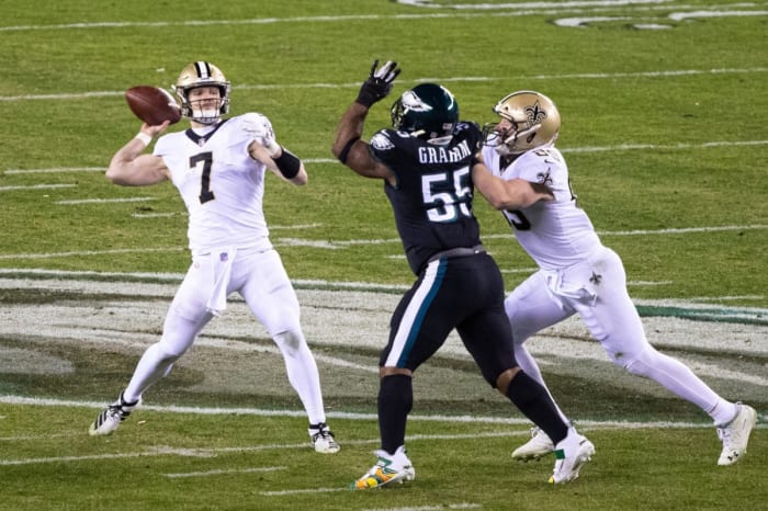 Dec 13, 2020; Philadelphia, Pennsylvania, USA; Saints quarterback Taysom Hill (7) throws a touchdown pass in front of Eagles defensive end Brandon Graham (55). Mandatory Credit: Bill Streicher-USA TODAY Sports